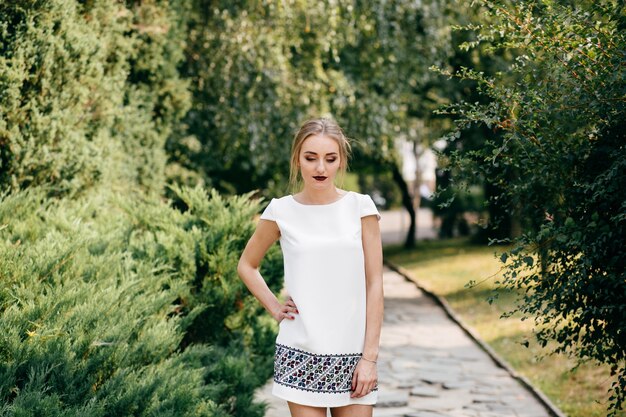 stylish businesswoman walking an posing