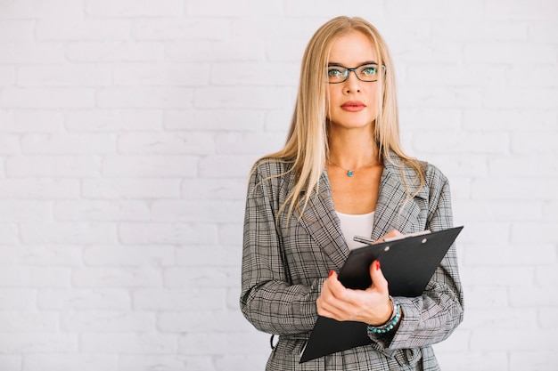 Stylish businesswoman with clipboard