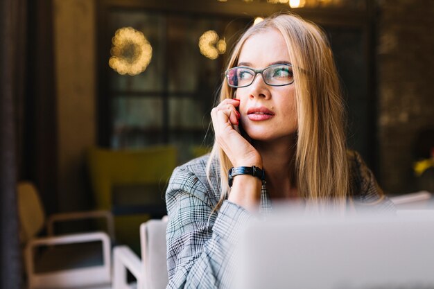 Stylish businesswoman with laptop in cosy coffee shop