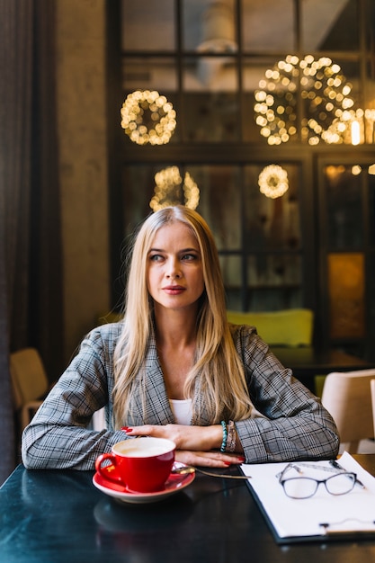 Stylish businesswoman with laptop in cosy coffee shop