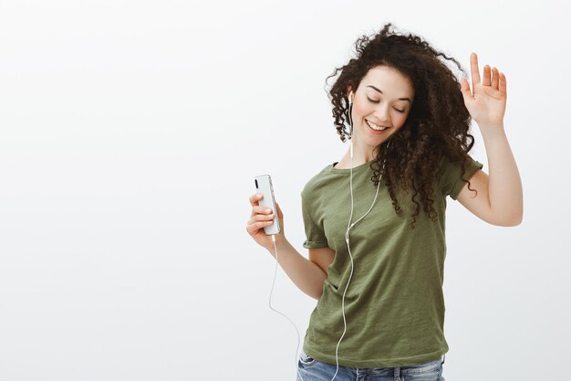 stylish carefree european girl with curly hair