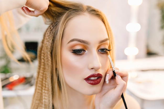 Stylish closeup portrait of gorgeous young woman in hairdresser salon preparing to party. Making hairstyle, makeup, stylist, professional, fashionable model, world of beauty, hairdressing service