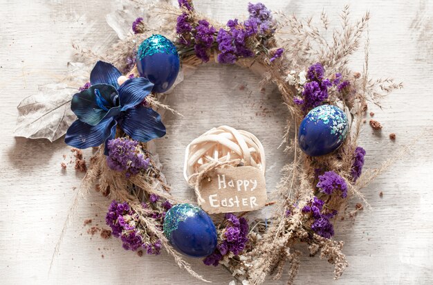 Stylish composition with an Easter wreath and eggs trend blue.