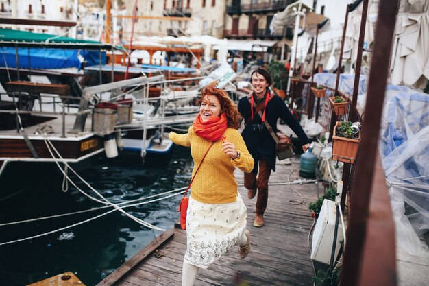 Stylish couple have fun on the marine coast