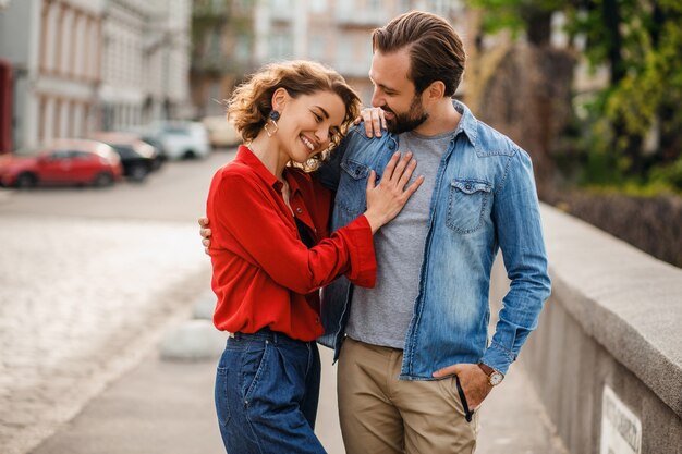 Stylish couple in love sitting in street on romantic trip