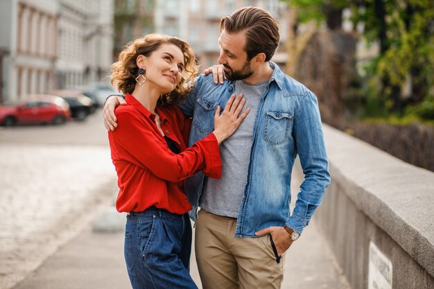 Stylish couple in love sitting in street on romantic trip