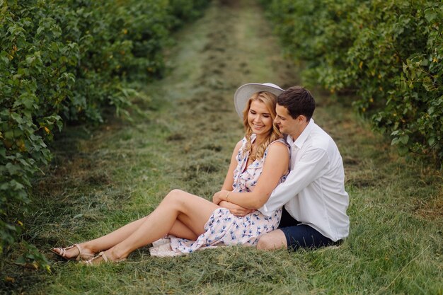 Stylish couple posing in the nature. Love and hugs