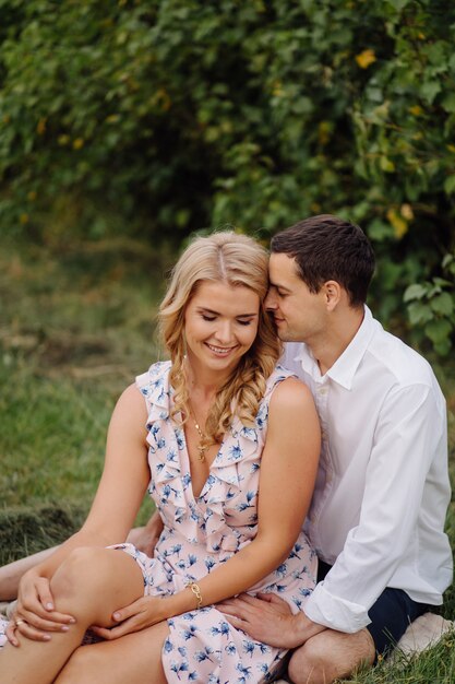 Stylish couple posing in the nature. Love and hugs