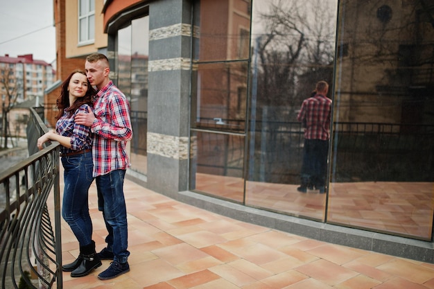 Stylish couple wear on checkered shirt in love together