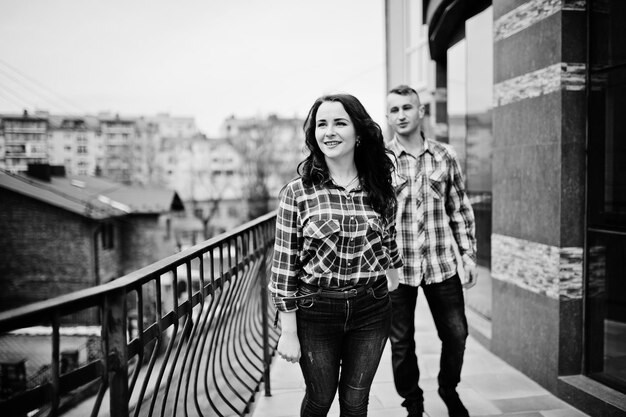 Stylish couple wear on checkered shirt in love together