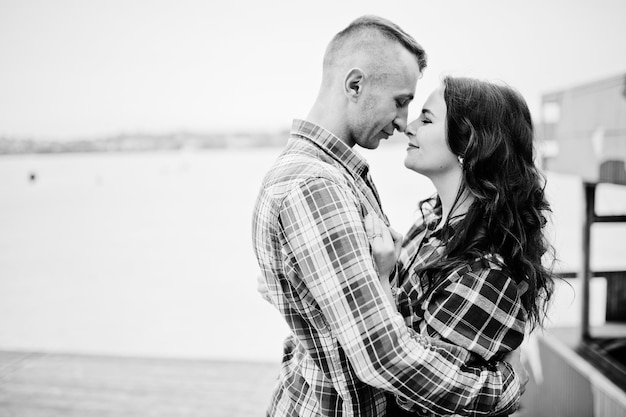 Stylish couple wear on checkered shirt in love together