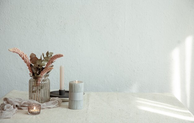 Stylish details of the interior decor against the background of a white wall with sunbeams.