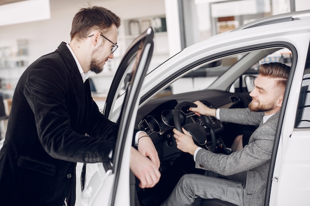 Stylish and elegant couple in a car salon