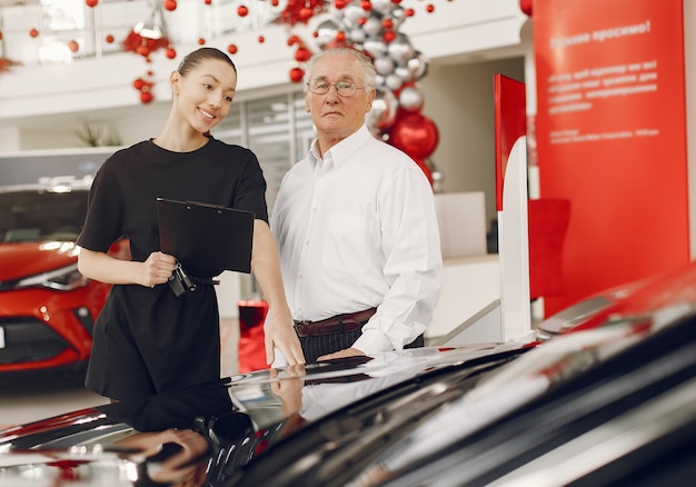 Stylish and elegant old man in a car salon