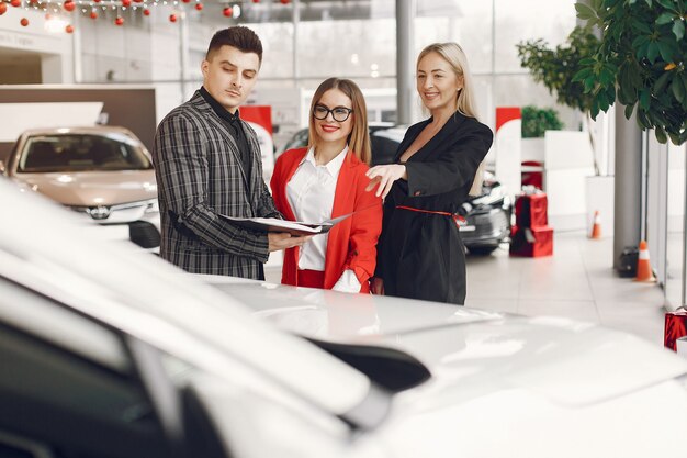 Stylish and elegant people in a car salon