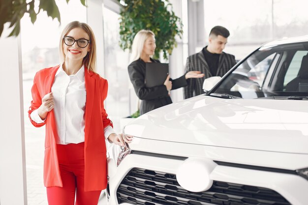 Stylish and elegant people in a car salon