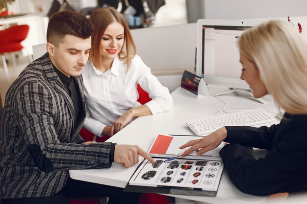 Stylish and elegant people in a car salon