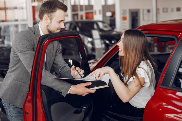 Stylish and elegant woman in a car salon