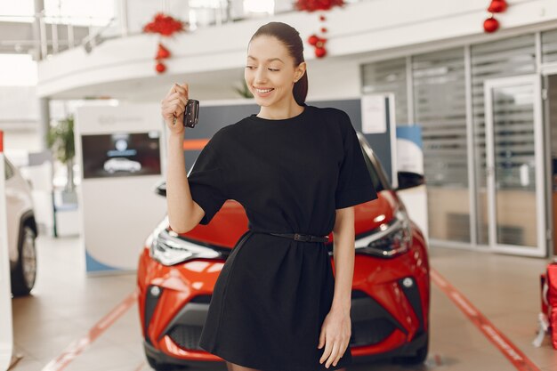 Stylish and elegant woman in a car salon