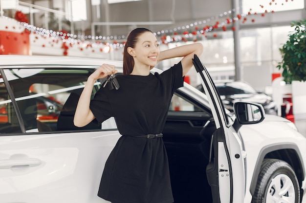 Stylish and elegant woman in a car salon