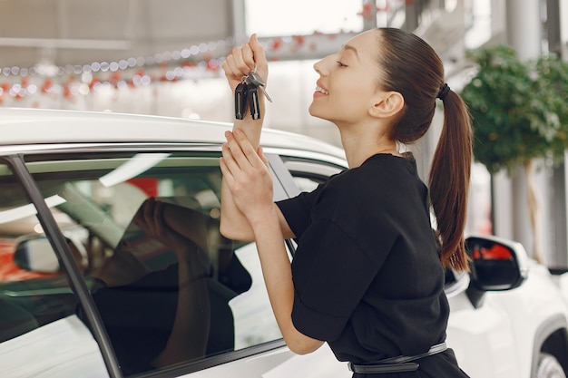 Stylish and elegant woman in a car salon