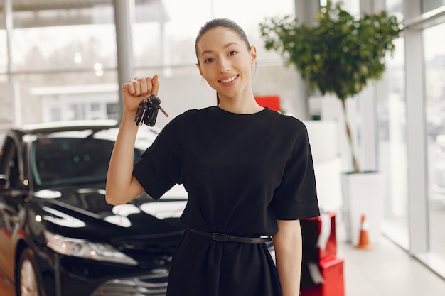 Stylish and elegant woman in a car salon