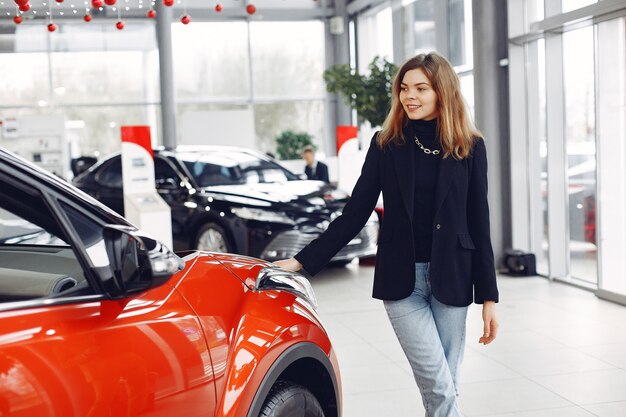 Stylish and elegant woman in a car salon