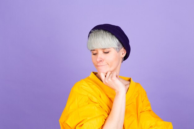 Stylish european woman on purple  wall