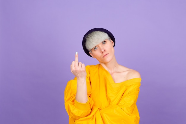 Stylish european woman on purple wall