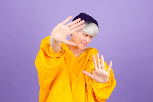 Stylish european woman on purple wall