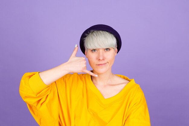 Stylish european woman on purple wall