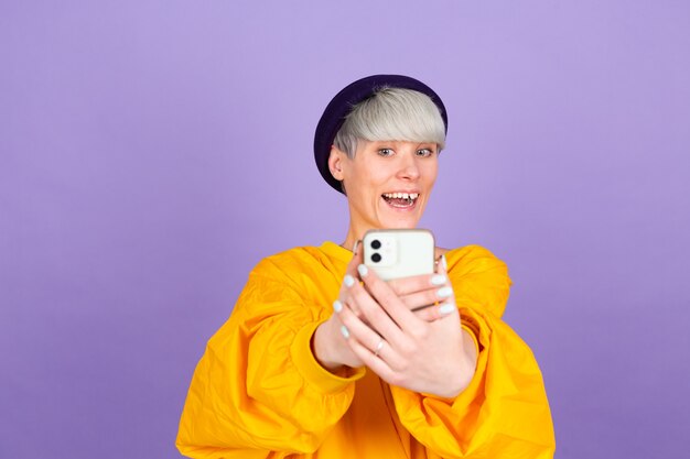 Stylish european woman on purple wall