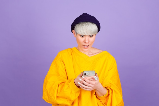 Stylish european woman on purple wall