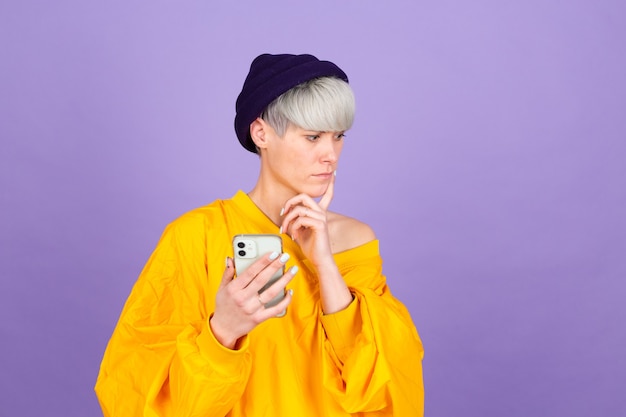 Stylish european woman on purple wall