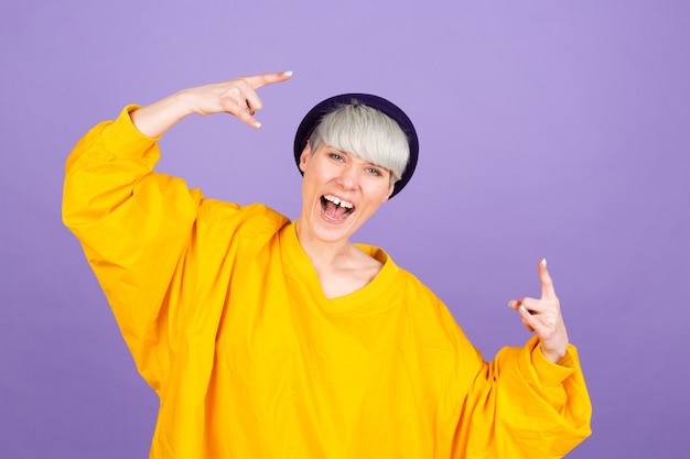 Stylish european woman on purple wall