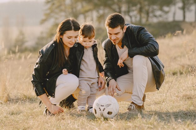 Stylish family walking on a sunny field