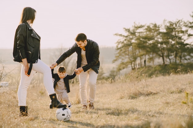 Stylish family walking on a sunny field