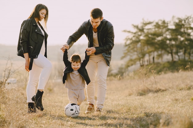 Stylish family walking on a sunny field