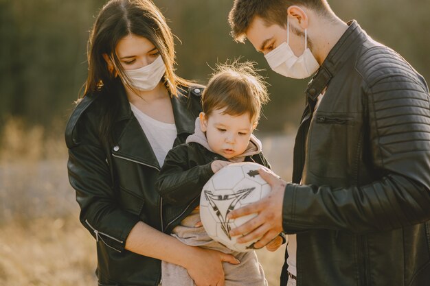 Stylish family walking on a sunny field