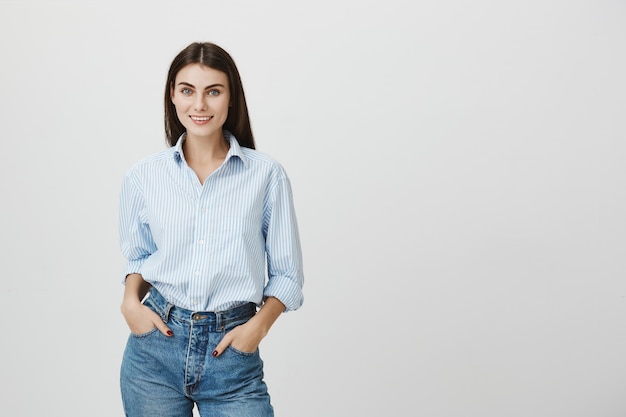 Stylish female entrepreneur smiling, hands in pockets