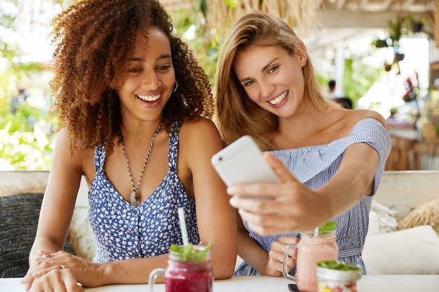 Stylish friends sitting in cafe