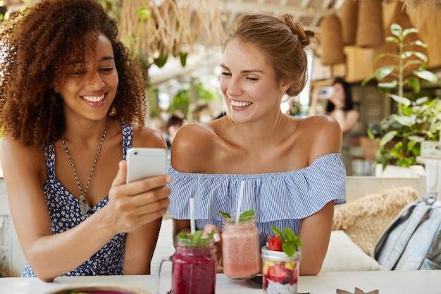 Stylish friends sitting in cafe