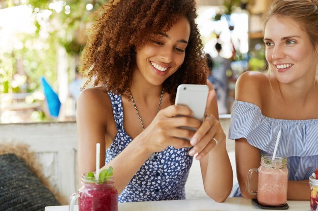 Stylish friends sitting in cafe