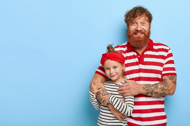 stylish ginger daughter and father posing together