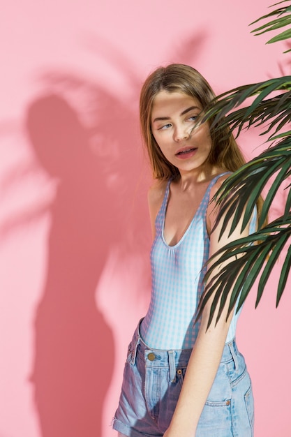 Stylish girl and palm tree leaves