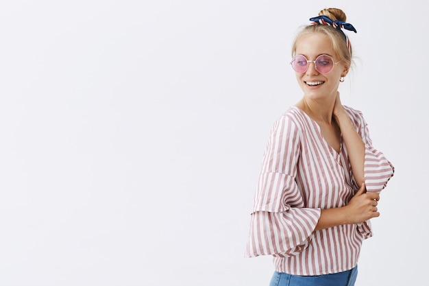 Free photo stylish girl posing against the white wall