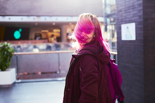 Free photo the stylish girl walking along shopping center