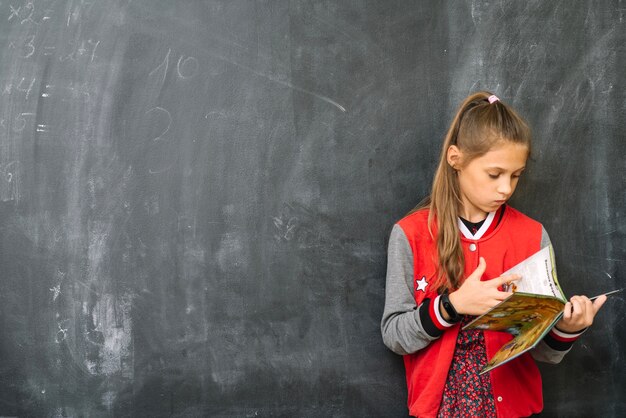 Stylish girl with textbook