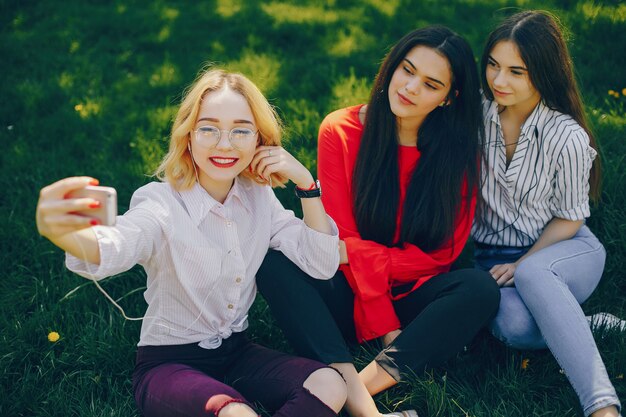 stylish girls sitting in a park