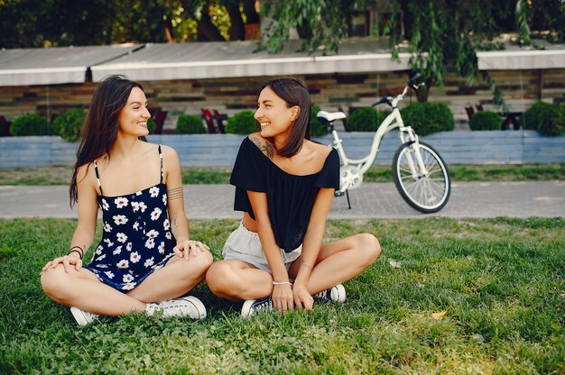 Stylish girls walking in a summer park